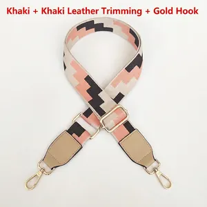 Detail of adjustable woven replacement bag strap with embroidery and gold metal hooks