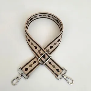 Detail view of adjustable diamond pattern bag strap with silver swivel hooks
