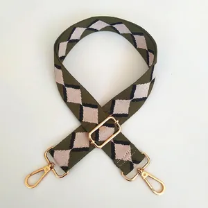 Close-up of adjustable diamond embroidered shoulder strap with polished gold hooks