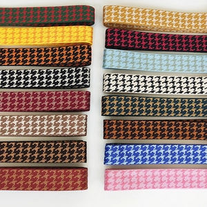 Detail of multi-color houndstooth woven shoulder straps with various jacquard patterns