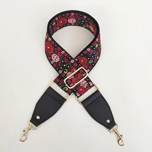 Detailed embroidery floral strap with gold metal hardware and black leather connectors
