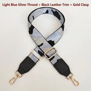 Detail of adjustable camouflage bag strap with light blue silver thread and gold hooks