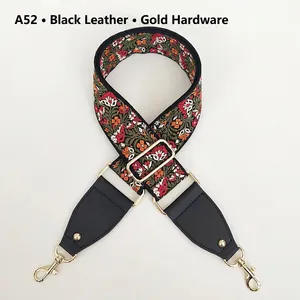 Close-up of ethnic floral embroidery handbag strap with black leather and gold hooks
