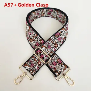Close-up of bohemian floral embroidery pattern on wide strap with gold metal lobster hooks