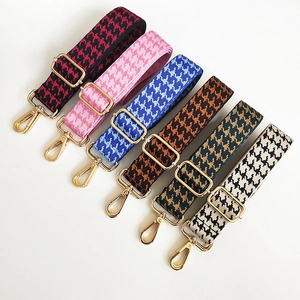 Close-up of six colorful houndstooth jacquard bag straps with golden lobster clasps