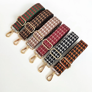 Collection of wide houndstooth jacquard shoulder straps with golden metal swivel hooks
