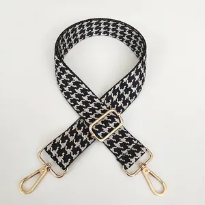 Adjustable wide replacement bag strap with classic black and white houndstooth jacquard pattern