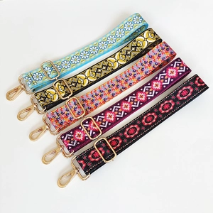 Detail of five ethnic style guitar straps with floral prints and golden metal buckles