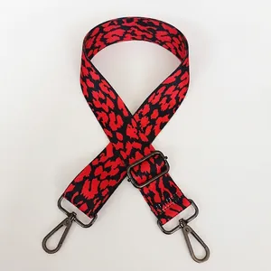 Adjustable wide replacement bag strap with red and black leopard pattern and gunmetal hooks