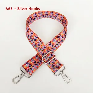 Macro detail of ethnic floral canvas bag strap with silver metal hook and adjustable buckle