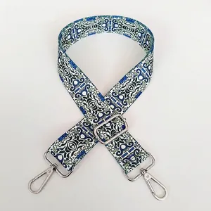 Detail of bohemian ethnic style wide bag strap with silver metal hooks and buckle