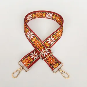 Close-up of ethnic floral embroidery on adjustable strap with gold lobster clasps