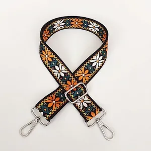 Ethnic style embroidered bag strap with orange daisy pattern and silver lobster hooks