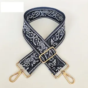 Detail of adjustable 5cm paisley canvas strap with high-quality gold swivel metal hooks