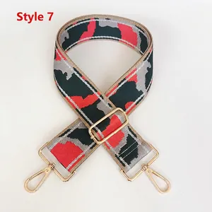 Macro detail of number 7 nylon shoulder strap with camouflage pattern and gold hooks