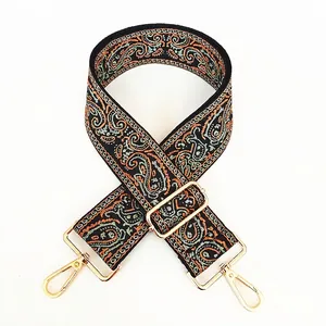 Detail of Persian style wide canvas bag strap with golden rotating lobster clasps