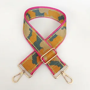 Close-up of wide nylon replacement strap with pink camouflage pattern and gold hardware