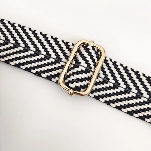 Macro view of black and white chevron cotton bag strap with gold adjustable buckle