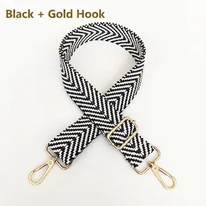 Adjustable black and white herringbone pattern strap with gold metal lobster clasps