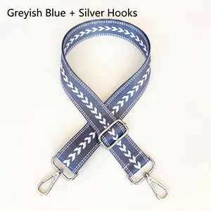 Detail of gray blue nylon jacquard wide bag strap with silver metal lobster clasps
