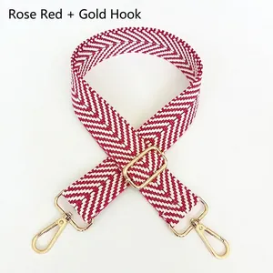 Close-up of rose red and white chevron shoulder strap with gold swivel hooks