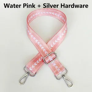 Detail of adjustable wide nylon shoulder strap in pink with white heart weaving and silver hooks