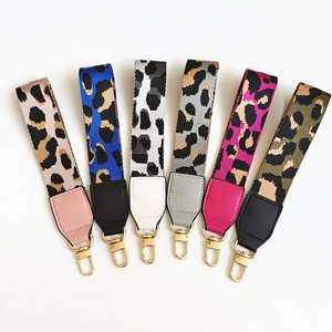 Detailed macro view of six leopard print phone wrist straps with gold lobster clasps