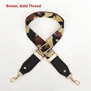 Detail of adjustable coffee camo bag strap with gold metallic thread and metal hooks