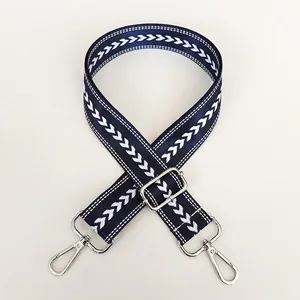 Navy blue adjustable nylon bag strap with white chevron pattern and silver swivel metal hooks