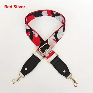 Detail of red and silver glitter camouflage wide shoulder strap with gold metal buckle