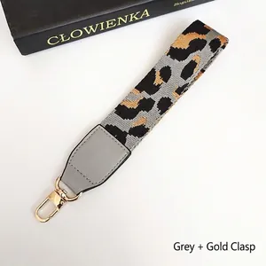 Detailed leopard print braided phone strap with grey leather trim and gold hook