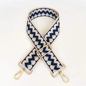 Adjustable woven shoulder strap with blue geometric waves and gold metal lobster clasps