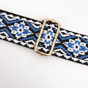 Close-up of ethnic geometric woven strap with gold metal buckle for adjustable length