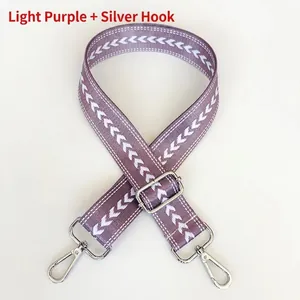 Detail of light purple nylon strap with white arrow pattern and silver metal hooks