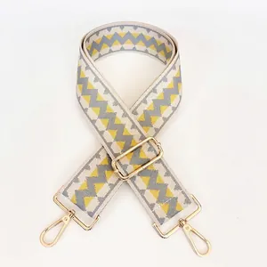 Macro shot of geometric weave shoulder strap with gold metal lobster claw hooks