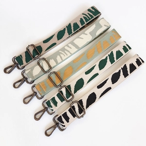 Adjustable wide embroidered canvas bag straps with geometric patterns and metal hooks