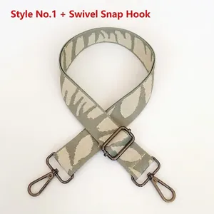 Detail view of adjustable wide embroidered strap with grey leaf pattern and gunmetal hooks