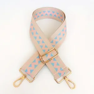Detail view of adjustable wide woven shoulder strap with pink and blue geometric pattern