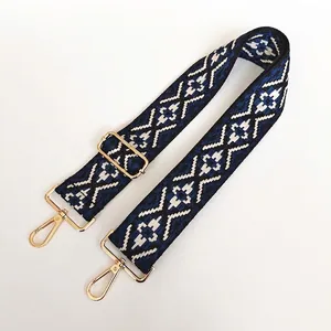 Detail of No. 22 jacquard canvas strap with geometric diamond pattern and gold hooks