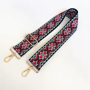 Close-up of ethnic woven pattern strap with golden metal swivel hooks and adjuster