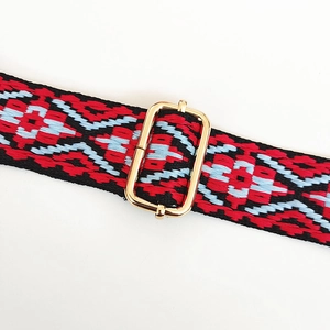 Detail of colorful jacquard guitar strap with golden metal adjustment buckle