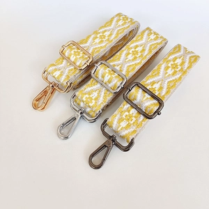 Close-up of bohemian canvas straps with gold, silver, and gunmetal swivel snap hooks