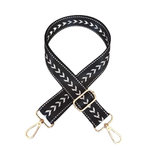 Adjustable nylon shoulder strap with black white arrow pattern and gold metal hooks