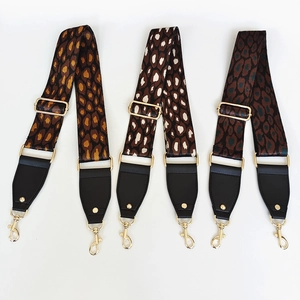 Leopard print nylon bag straps with black leather ends and gold metal buckles