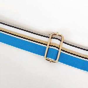 Close-up of adjustable colorful striped canvas bag strap with gold metal buckle