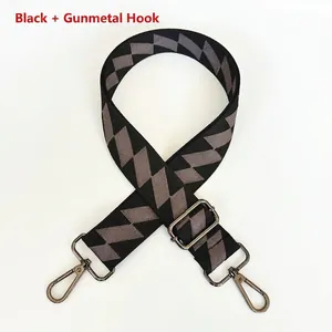 Close-up of black and grey geometric patterned bag strap with gun-metal swivel hooks