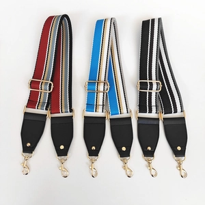Three adjustable striped canvas shoulder straps with gold hardware for handbags