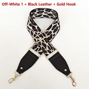 Close-up of leopard print nylon strap with black leather ends and gold metal hooks