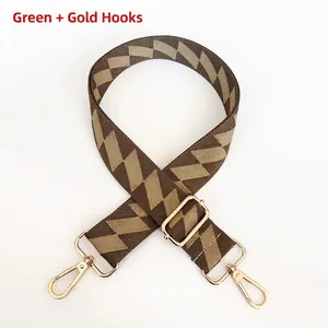 Adjustable green geometric patterned bag strap with durable gold metal hooks