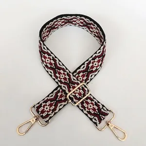 Close-up of ethnic geometric jacquard bag strap with gold metal spring hooks